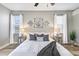 Inviting bedroom with neutral decor, light hardwood floors, and large windows at 8640 Stone Harbour Loop, Bradenton, FL 34212