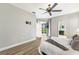 Bedroom featuring hardwood floors, a ceiling fan, and a sliding door with access to the outdoors at 8640 Stone Harbour Loop, Bradenton, FL 34212
