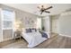 Bedroom with hardwood floors, ceiling fan, ensuite bathroom, and neutral wall color at 8640 Stone Harbour Loop, Bradenton, FL 34212