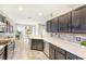 Updated kitchen features stainless steel appliances, light countertops, and open layout to dining area at 8640 Stone Harbour Loop, Bradenton, FL 34212