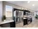 Bright kitchen with stainless steel refrigerator, gas range, and modern dark wood cabinetry at 8640 Stone Harbour Loop, Bradenton, FL 34212