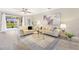 Comfortable living room showcasing stylish furniture, wood floors and natural light at 8640 Stone Harbour Loop, Bradenton, FL 34212