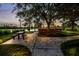 Beautiful park with picnic tables, lush greenery, and a tranquil lake in the background at 8640 Stone Harbour Loop, Bradenton, FL 34212