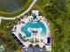 Aerial view of the community pool area with blue water, slides, umbrellas, and plenty of seating at 8932 Isabella Cir, Parrish, FL 34219