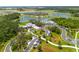Aerial view of community clubhouse, pool, and surrounding amenities near ponds and green spaces at 8932 Isabella Cir, Parrish, FL 34219