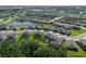 Expansive aerial view showcasing a community with well-maintained homes and serene lake at 8932 Isabella Cir, Parrish, FL 34219
