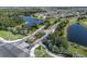 Picturesque aerial view of a community entrance with lush landscaping and serene lake views at 8932 Isabella Cir, Parrish, FL 34219