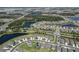 Scenic aerial view of a community with a variety of home styles, lakes, and roadways at 8932 Isabella Cir, Parrish, FL 34219