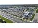 Aerial view of shopping center with a grocery store, retail shops, and ample parking at 8932 Isabella Cir, Parrish, FL 34219