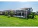Manicured backyard features a screened-in pool, lush lawn, and inviting outdoor spaces at 8932 Isabella Cir, Parrish, FL 34219
