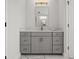 Bathroom vanity area with a gray vanity and a mirror at 8932 Isabella Cir, Parrish, FL 34219
