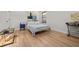 Well-lit bedroom boasting hardwood floors, a comfortable bed, and an inviting atmosphere at 8932 Isabella Cir, Parrish, FL 34219