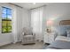 Cozy bedroom with a serene window view, comfortable chair, and calming decor at 8932 Isabella Cir, Parrish, FL 34219