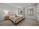 Bright bedroom with a large window, plush carpeting, and neutral decor at 8932 Isabella Cir, Parrish, FL 34219