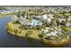 Aerial view of a luxurious community pool with palm trees, cabanas, lounge chairs and lake at 8932 Isabella Cir, Parrish, FL 34219