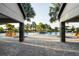 Pool area with pavers and stone columns, surrounded by palm trees and lounge chairs at 8932 Isabella Cir, Parrish, FL 34219