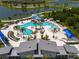 Aerial view of the community pool with a water slide, sun loungers, and shaded seating at 8932 Isabella Cir, Parrish, FL 34219