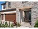 A stone walkway leads to the front entrance, with a 3 car garage on the left and tropical landscaping at 8932 Isabella Cir, Parrish, FL 34219