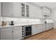 Gourmet kitchen featuring white cabinets, stainless steel appliances, and a built-in wine cooler for added convenience at 8932 Isabella Cir, Parrish, FL 34219