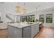 Spacious kitchen island with stone countertops, sink, and seating for four at 8932 Isabella Cir, Parrish, FL 34219