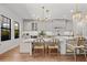 Elegant eat-in kitchen with white cabinets, modern appliances, and stylish seating area for casual dining at 8932 Isabella Cir, Parrish, FL 34219