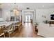 Bright open living space with kitchen featuring wood floors and plenty of natural light from front door at 8932 Isabella Cir, Parrish, FL 34219