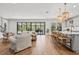 Open-concept living room flowing into kitchen, featuring large sliding doors and a view of the pool at 8932 Isabella Cir, Parrish, FL 34219