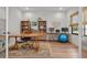 Bright and spacious office space featuring wood floors, ample shelving, and a comfortable work area at 8932 Isabella Cir, Parrish, FL 34219