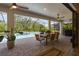 Covered outdoor dining area with a view of the screened-in pool at 8932 Isabella Cir, Parrish, FL 34219