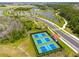 Aerial view of the community pickleball courts, lush landscaping, and connecting paths at 8932 Isabella Cir, Parrish, FL 34219