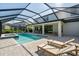 Relaxing screened-in pool with lounge chairs and manicured landscaping at 8932 Isabella Cir, Parrish, FL 34219