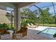 Inviting screened-in pool area with outdoor lounge chairs and lush landscaping at 8932 Isabella Cir, Parrish, FL 34219