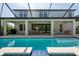 Sparkling pool and spacious deck offer a relaxing backyard retreat and covered outdoor dining at 8932 Isabella Cir, Parrish, FL 34219