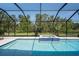 Private pool and spa surrounded by screened enclosure and lush landscaping at 8932 Isabella Cir, Parrish, FL 34219