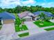 Aerial view of a well-kept neighborhood featuring houses with manicured lawns and palm trees at 9229 52Nd E Ave, Palmetto, FL 34221