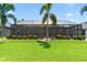 Backyard showcasing a screened-in pool, mature palm trees, and meticulous landscaping at 9229 52Nd E Ave, Palmetto, FL 34221