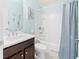 Bathroom featuring a single sink vanity with framed mirror and a shower and tub combo at 9229 52Nd E Ave, Palmetto, FL 34221
