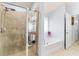 Bathroom featuring glass enclosed shower and separate tub at 9229 52Nd E Ave, Palmetto, FL 34221