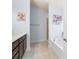 Bathroom featuring a walk-in shower and a tub under a window at 9229 52Nd E Ave, Palmetto, FL 34221