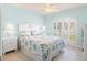 Bedroom with blue walls, plantation shutters, and beach-themed decor at 9229 52Nd E Ave, Palmetto, FL 34221