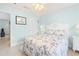 Light and airy bedroom featuring calming aqua walls, hardwood floors, and palm tree bedding at 9229 52Nd E Ave, Palmetto, FL 34221