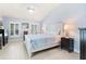 Bright bedroom with a vaulted ceiling and a white wood bed with blue patterned bedding at 9229 52Nd E Ave, Palmetto, FL 34221