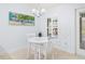 Cozy breakfast nook with a round table, white chairs, and natural light from the shuttered window at 9229 52Nd E Ave, Palmetto, FL 34221