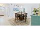 Open dining room showcasing wooden table and chairs, complemented by a turquoise accent piece at 9229 52Nd E Ave, Palmetto, FL 34221