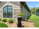 Home's exterior with stone accents, manicured landscaping, and a view of a window with dark trim at 9229 52Nd E Ave, Palmetto, FL 34221