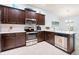 Modern kitchen boasts stainless steel appliances, wooden cabinets, and white countertops at 9229 52Nd E Ave, Palmetto, FL 34221