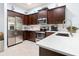 Well-equipped kitchen with stainless steel appliances, dark wood cabinets, and a spacious white countertop at 9229 52Nd E Ave, Palmetto, FL 34221