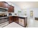 Modern kitchen boasts stainless steel appliances, wooden cabinets, and white countertops at 9229 52Nd E Ave, Palmetto, FL 34221