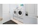 Laundry room features stacked washer and dryer units, door to the backyard, and storage shelf at 9229 52Nd E Ave, Palmetto, FL 34221