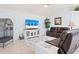 Cozy living room featuring a brown leather sofa and a TV atop a white cabinet with glass doors at 9229 52Nd E Ave, Palmetto, FL 34221